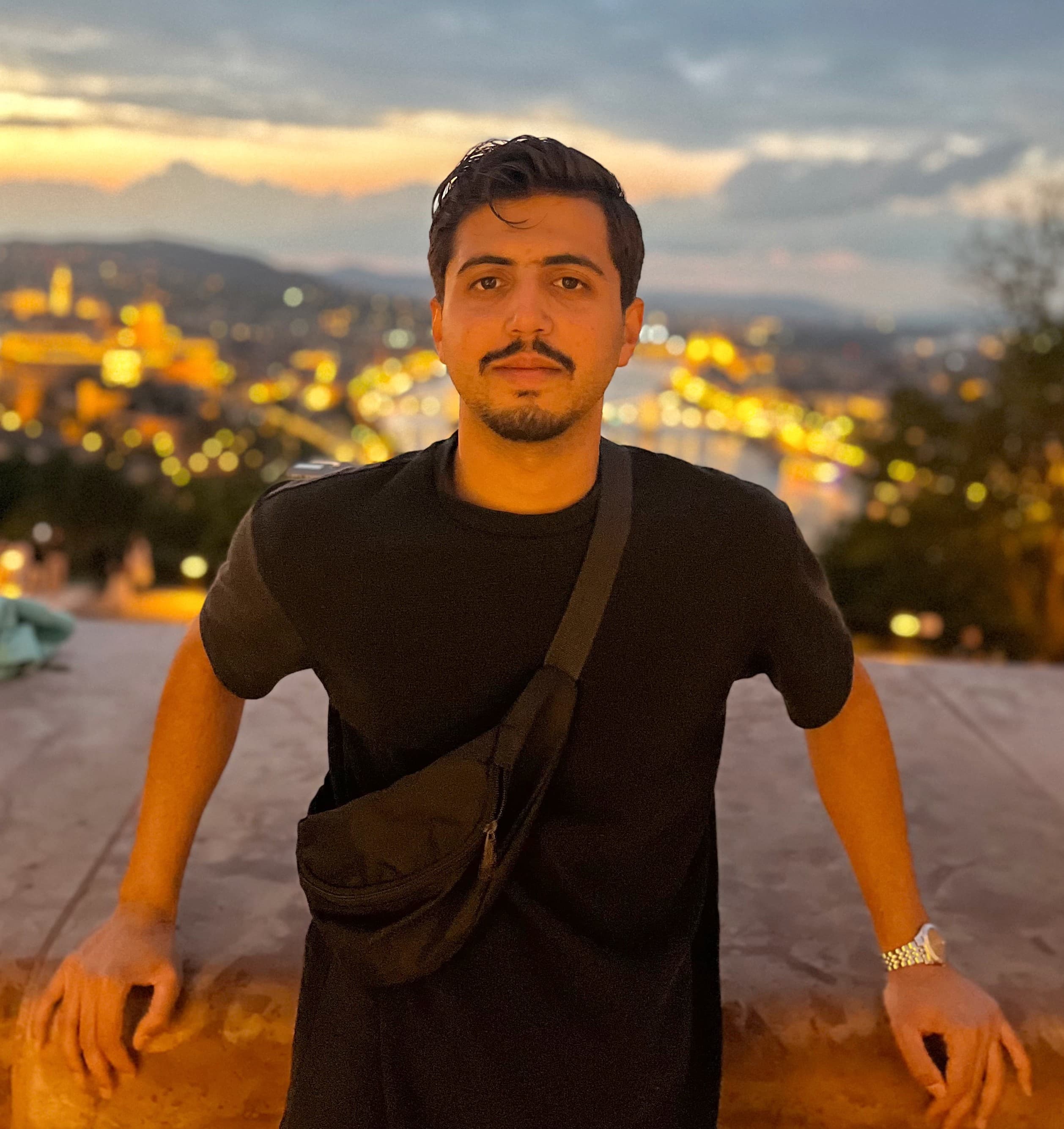 Motasem AbuBaraka above Budapest at dusk, the city behind